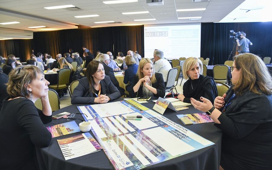 Participants in discussion around a workshop table
